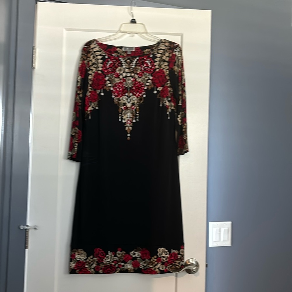 Dress has clear rhinestones for added flare.